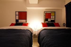 two beds in a room with stained glass windows at ダイトービル304 in Tokyo