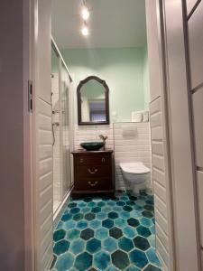 a bathroom with a toilet and a sink and a mirror at Ratuszowa 13 in Prudnik +23 photos