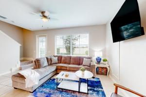 a living room with a couch and a tv at Pelican Escape in Davenport