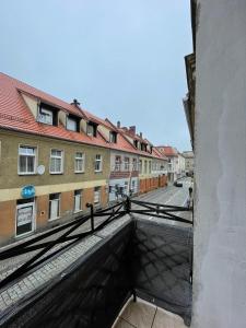 a view of a street from a balcony of a building at Ratuszowa 13 in Prudnik