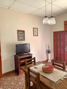 a living room with a wooden table and a television at Departamento VILLA NUEVA in Villa María