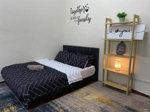 a bedroom with a bed with a sign on the wall at Tulip Hijau Bukit Beruntung in Rawang