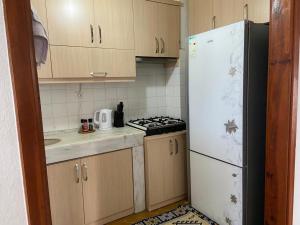 a kitchen with a white refrigerator and a stove at Side home beach in Side