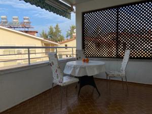 a table and two chairs sitting on a balcony at Side home beach in Side