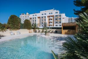 a swimming pool in front of a building at Le Drip's in Marseille