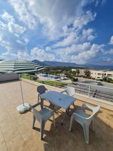 a patio with a table and chairs and an umbrella at Penthouse with rooftop terrace in Akanthou
