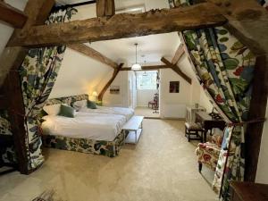 a bedroom with a bed in a room with beams at Blyth Hall in Coleshill