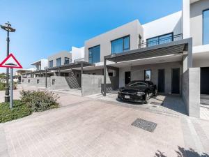 a car parked in front of a house at StoneTree - 3 BR with 1 Maids Room Villa in Camelia - Arabian Ranches in Dubai