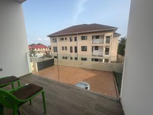 a balcony with a view of a building at Big chill stays in Accra