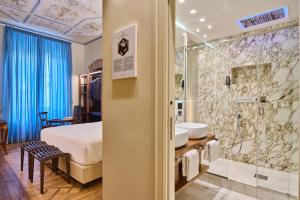 a hotel room with a bed and a shower at Duomo Luxury Florence in Florence +89 photos