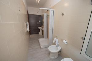 a bathroom with a toilet and a shower and a sink at Hotel Imperiale in Terzigno