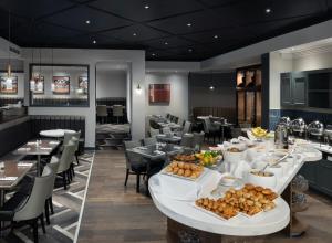 a buffet table with food in a restaurant at Edinburgh Marriott Hotel Holyrood in Edinburgh