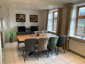 a dining room with a wooden table and chairs at Ferienhaus Alte Mühle in Stoltebüll