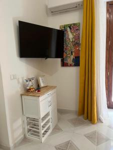 a flat screen tv hanging on a wall at GL Golden City Apartments in Catania