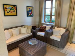 a living room with a couch and two chairs at Ferienhaus Alte Mühle in Stoltebüll +21 photos