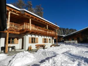 a building with a deck in the snow at Laerchhof in Collalbo