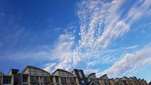 a row of buildings under a cloudy sky at G Residence - 2BR Family Suite Barrington Night Market - 4 in Brinchang