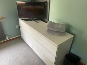 a white dresser with a television on top of it at Mountain Suite, Stunning Views, Brecon Beacons in Llanhamlach