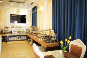a room with blue curtains and a table with food at Tuyet Son Hotel (TS Ocean Hotel) in Da Nang