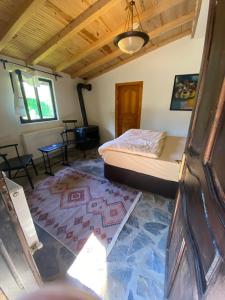 a bedroom with a bed and a rug on the floor at Abant Taş Konak in Dereceören