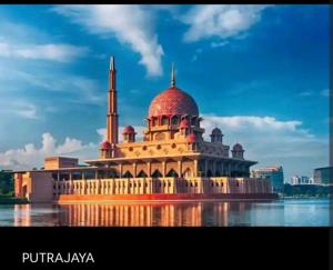 a large building with a mosque on the water at MamaQarl Homestay@KLIA&PICC+ Wi-Fi+Neflix 7pax in Sepang