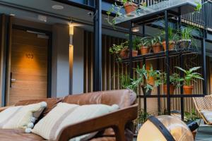 アムステルダムにあるホテル デ ハレンの鉢植えの植物が植えられたバルコニーのソファ