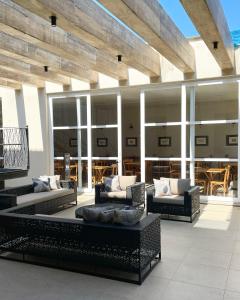 a patio with couches and tables on a building at Pousada Villa Alferes in Tiradentes