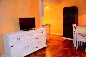 a white dresser with a flat screen tv on top of it at Silver Wolf Wood in Krakow