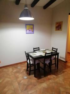 a dining room table with two chairs and a light at One bedroom appartement with city view enclosed garden and wifi at Caltanissetta in Caltanissetta
