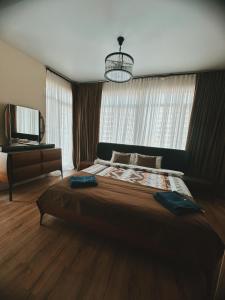 a bedroom with a large bed and a large window at Prestigio Sea view apart in Batumi +35 photos
