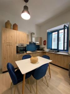 a kitchen with a table and chairs in a room at Stylish Valletta Apartment in Valletta