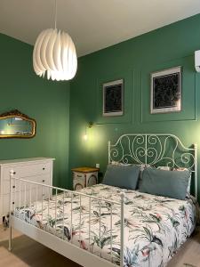 a bedroom with a bed with a green wall at Stylish Valletta Apartment in Valletta