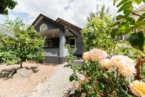 a house with flowers in front of it at Blue Caribou Bungalow in Penticton