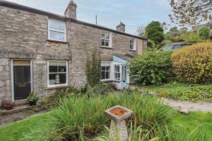 a brick house with a sign in front of it at 3 Tower View in Grange Over Sands