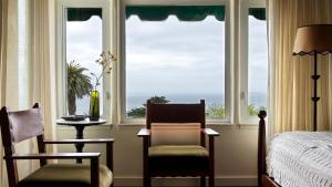 a bedroom with a window with a view of the ocean at La Playa Hotel in Carmel