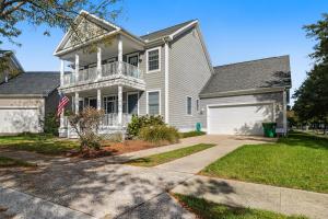a white house with a porch and a driveway at Bear Trap Dunes - 96 Willow Oak in Ocean View