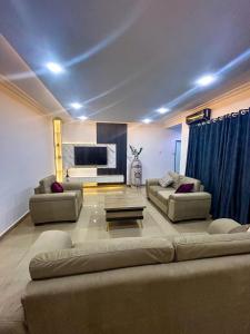 a living room with two couches and a television at 1118 Serenity Residence in Abuja