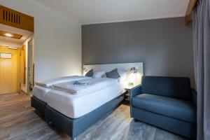 Ένα ή περισσότερα κρεβάτια σε δωμάτιο στο Coffee Fellows Hotel Leipheim Süd +25 φωτογραφίες