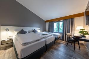 Postel nebo postele na pokoji v ubytování Hotel Leipheim Süd