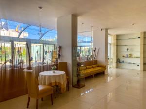 sala de estar con mesa y sofá amarillo en Hotel Degli Haethey, en Otranto