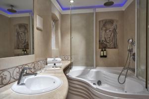 a bathroom with a sink and a bath tub at Atlantica Aeneas Resort in Ayia Napa