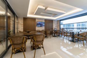 a restaurant with tables and chairs and a large window at Rubby Kadıköy in Istanbul