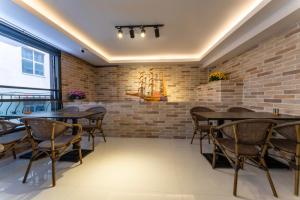 a dining room with brick walls and wooden tables and chairs at Rubby Hotel Kadıköy in Istanbul