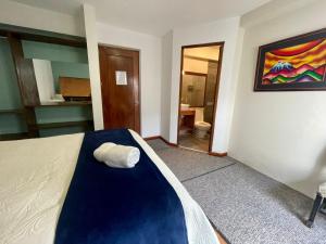 Un dormitorio con una cama con una toalla. en Hotel Mia Inn, en La Paz