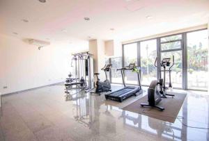 a gym with several treadmills and elliptical machines at Luxury Apartment/ Sea views/Pool/Gym in San Jorge