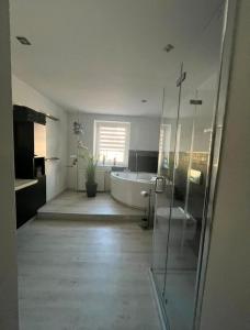 a large bathroom with a tub and a shower at Ferienwohnung in Ehrenfriedersdorf in Ehrenfriedersdorf