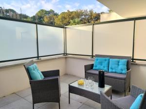 a balcony with two chairs and a table at Le Moulin du Lac, Terrasse, Neuf in Saint-Paul-lès-Dax