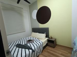 a bedroom with a bed with black and white stripes at Sky InfinityPool 2R2B 2-6pax 5minJonker Malacca in Melaka