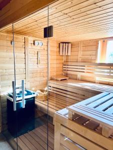 a sauna with a tub and a sink at Chalet Tobeleck - CharmingStay in Flumserberg +5 photos