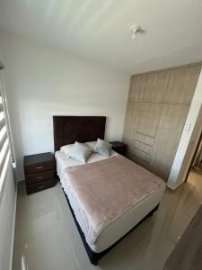 a bedroom with a large bed with a wooden headboard at Casa Pardo in Monterrey